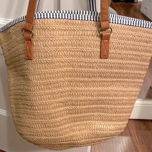 Large straw tote great for the beach. Blue and white stripe interior